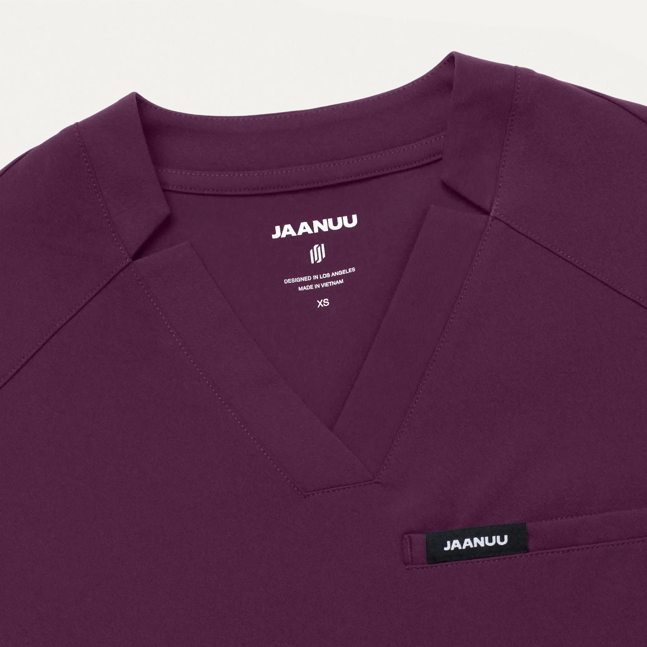 Jaanuu Women's Helia Slim Notched V-Neck Scrub Top - Dark Amethyst